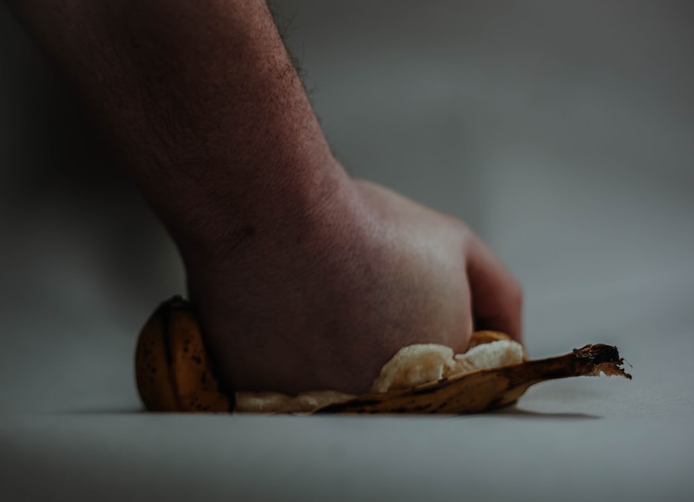 person holding brown wooden chopping board