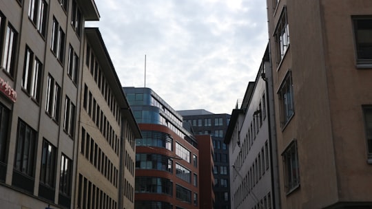 brown and black concrete building under white clouds during daytime in Bremen Germany