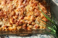 A golden-brown cowboy chicken casserole fresh out of the oven with bubbling cheese and crispy bacon.