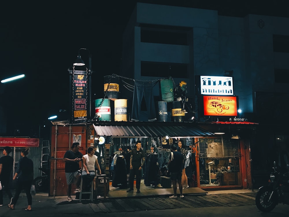 people walking on sidewalk during nighttime