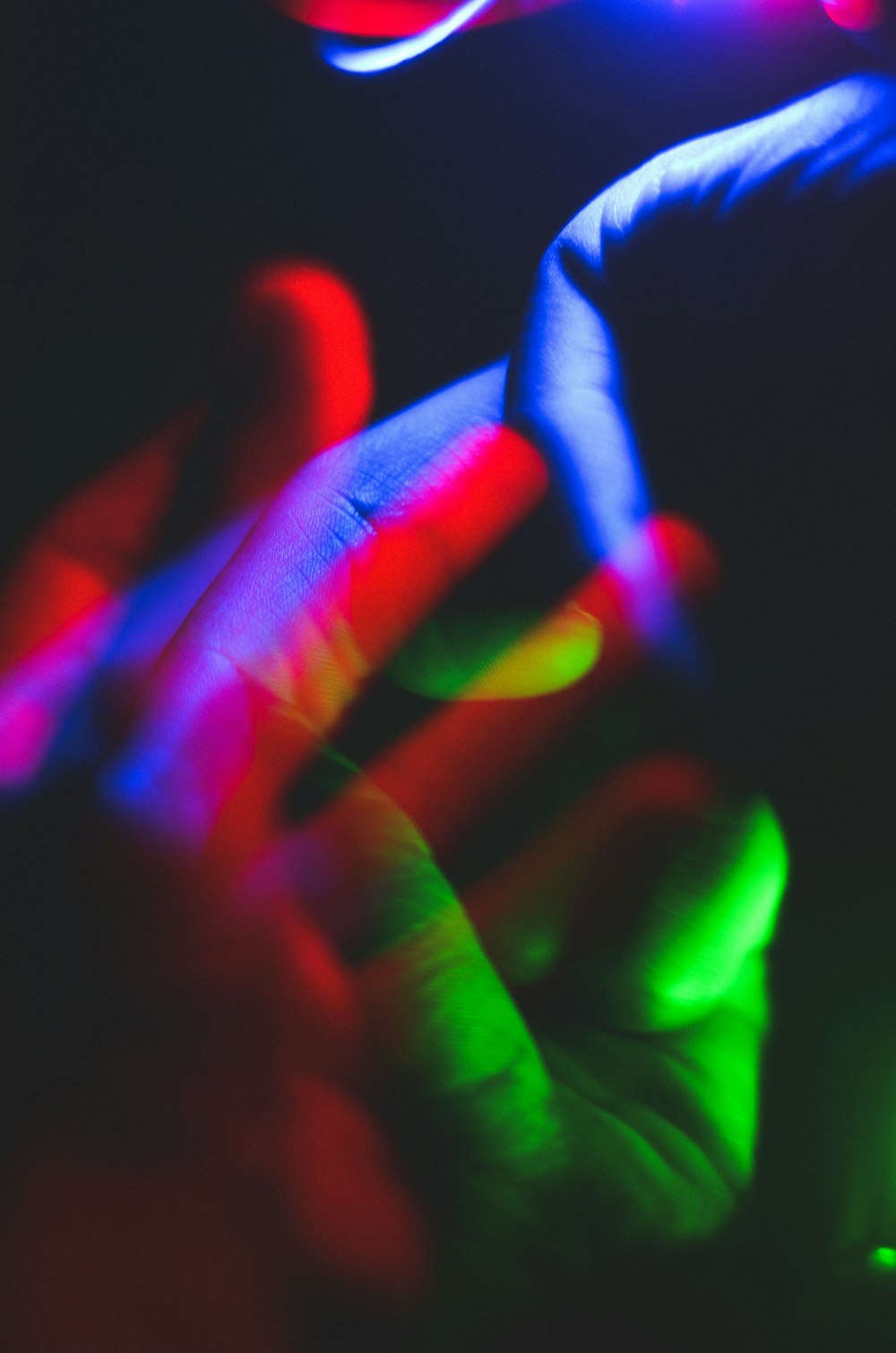 persons hand with purple light