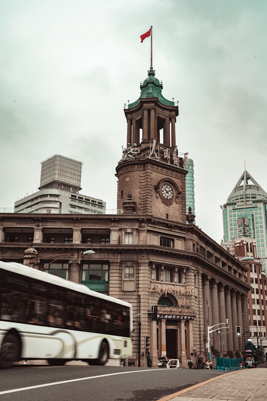 brown concrete building under white clouds during daytime in Shanghai Postal Museum China