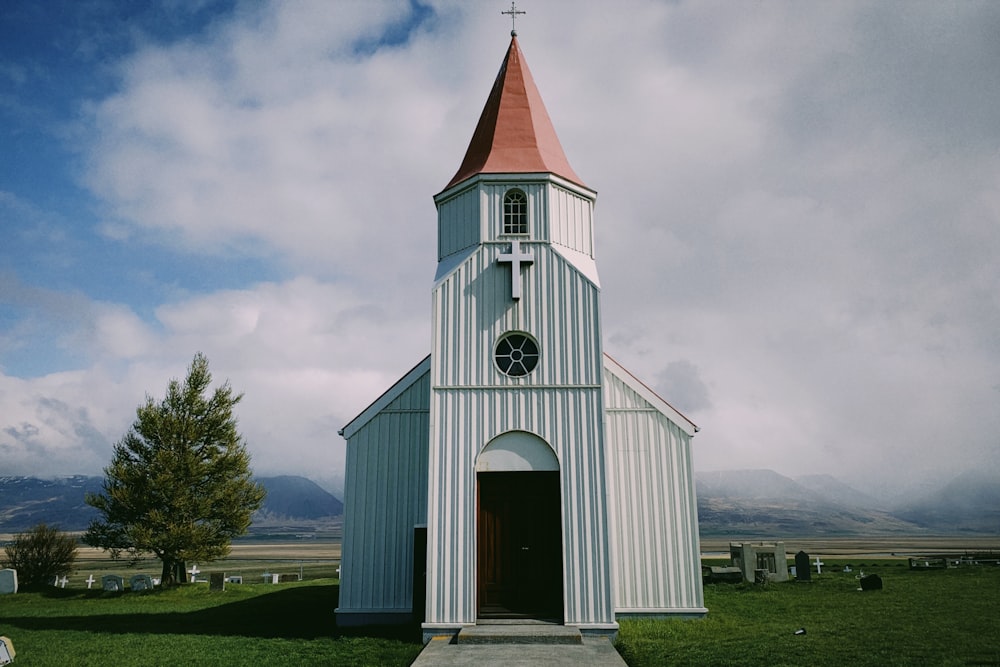 white and brown church under cloudy sky