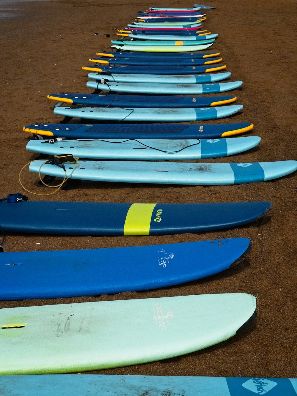 blue and yellow kayaks on brown sand