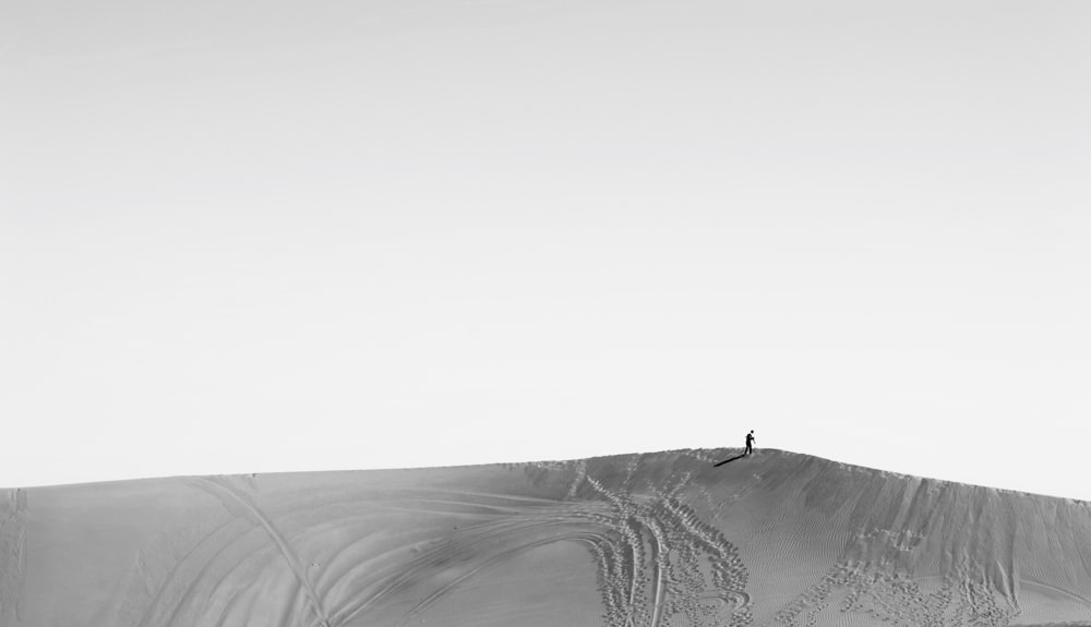 person standing on sand dunes