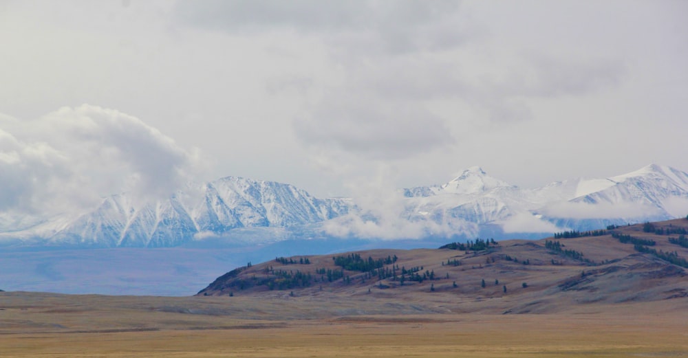 snow covered mountain under cloudy sky during daytime