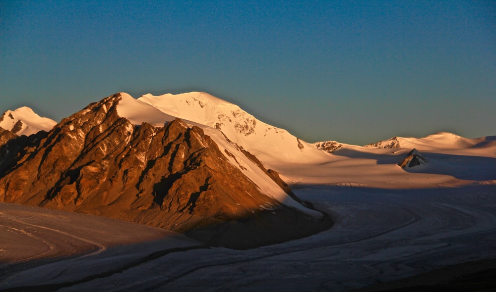 snow covered mountain under blue sky during daytime