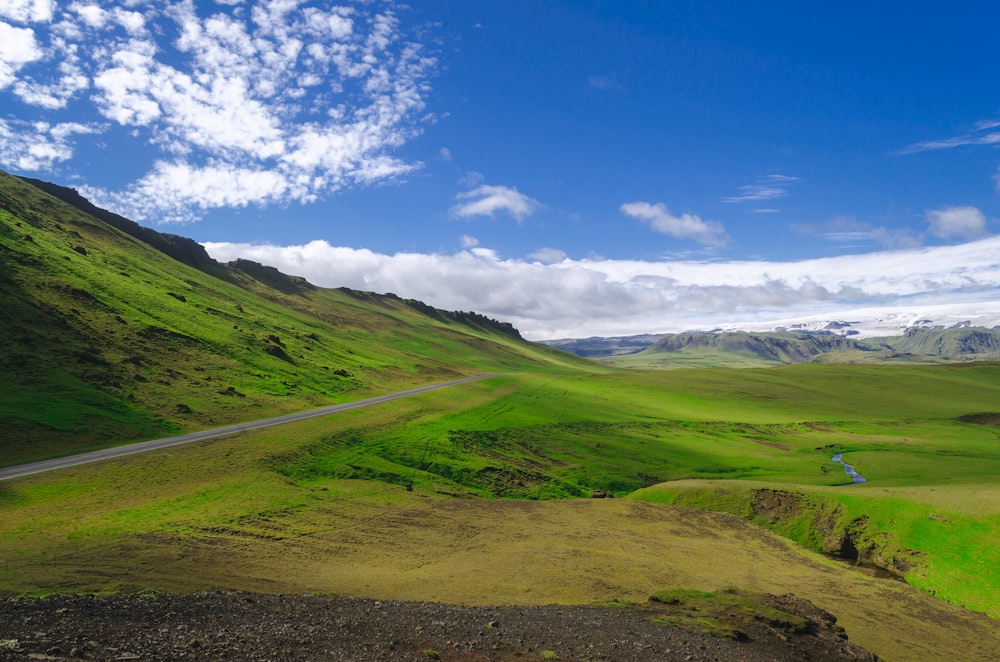 green grass field under blue sky during daytime