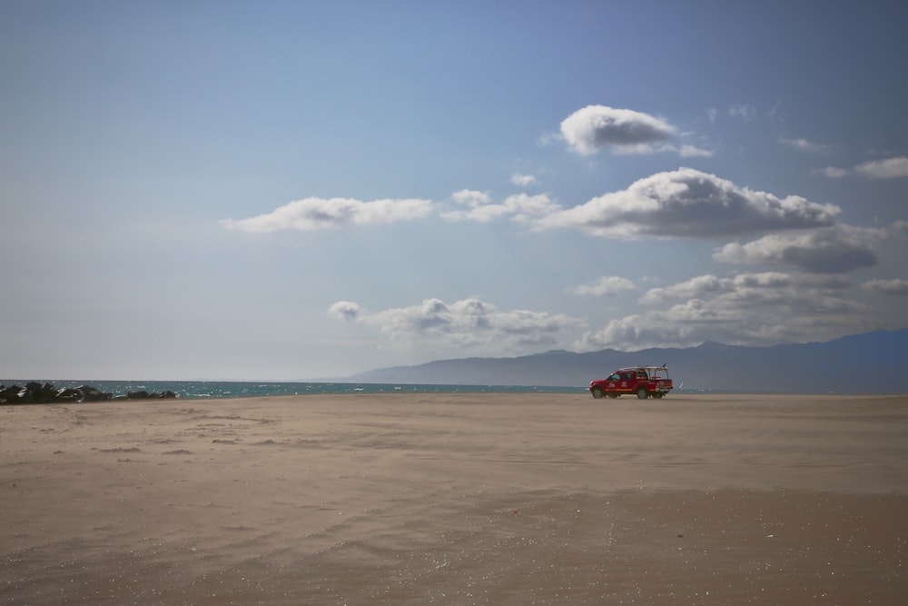 red car on beach during daytime
