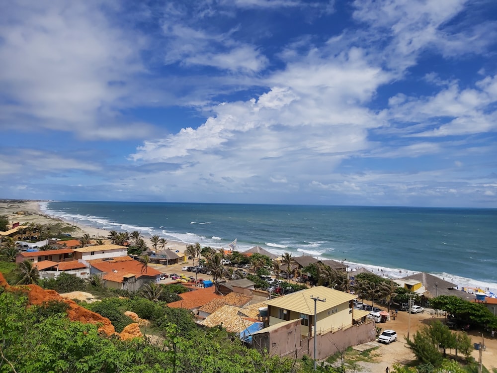 houses near sea under blue sky during daytime