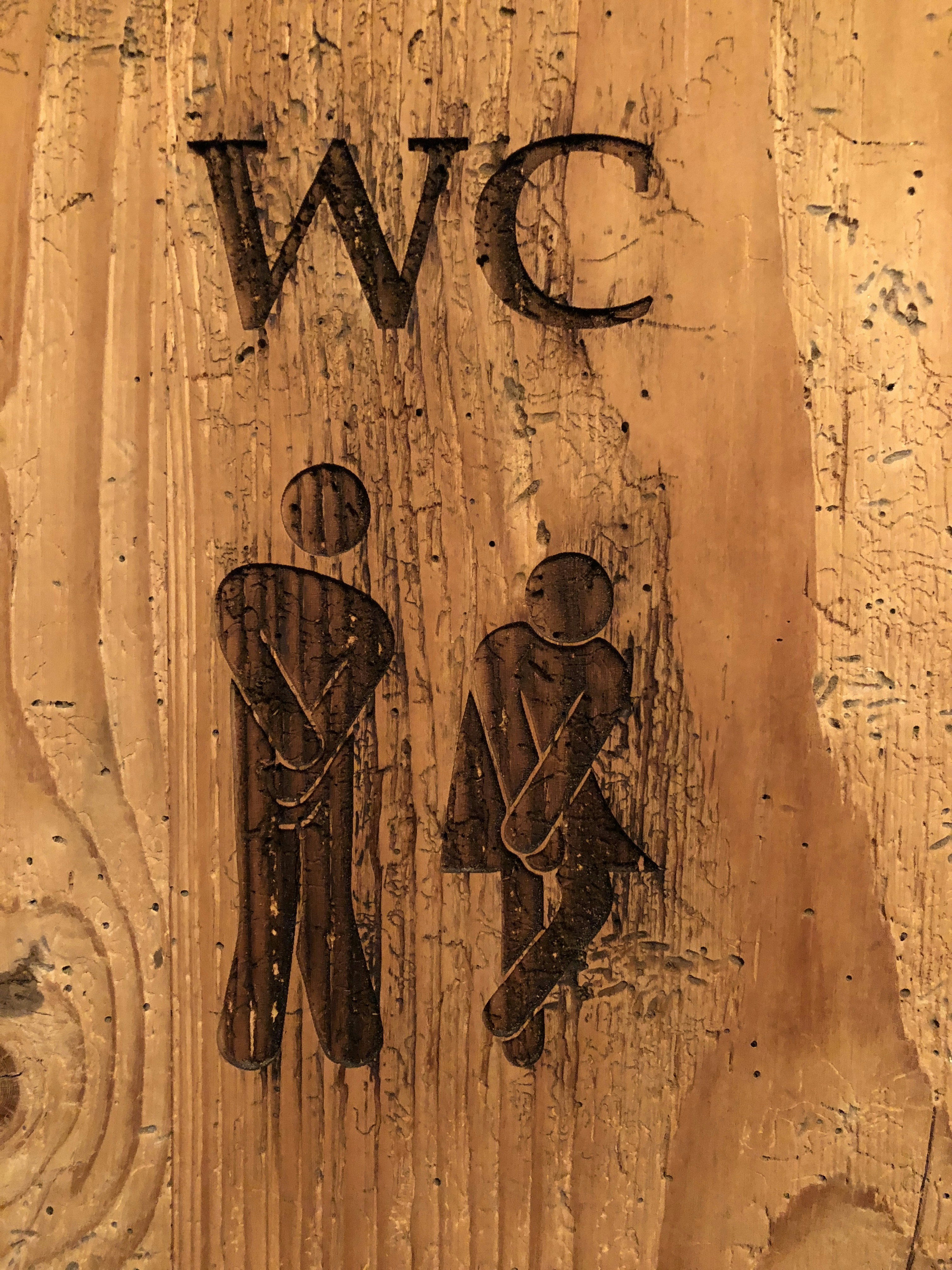 brown wooden human figure wall decor