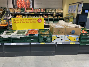 Close-up of premium consumer goods on German retail shelves with clear pricing tags.