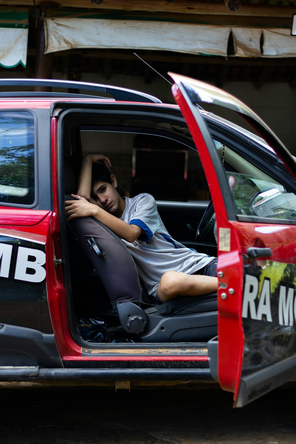 man in blue t-shirt sitting on car seat