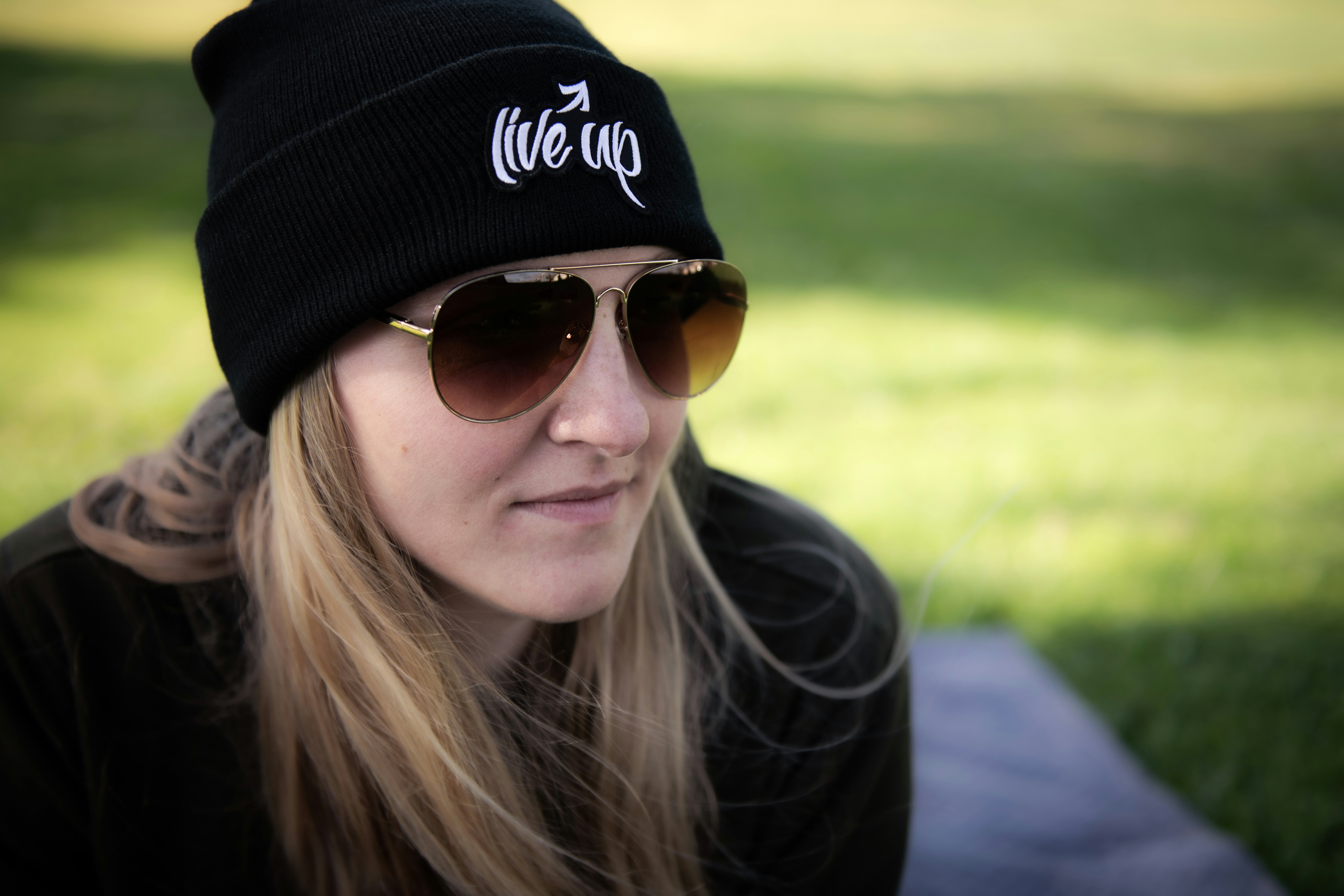 woman in black cap and black sunglasses