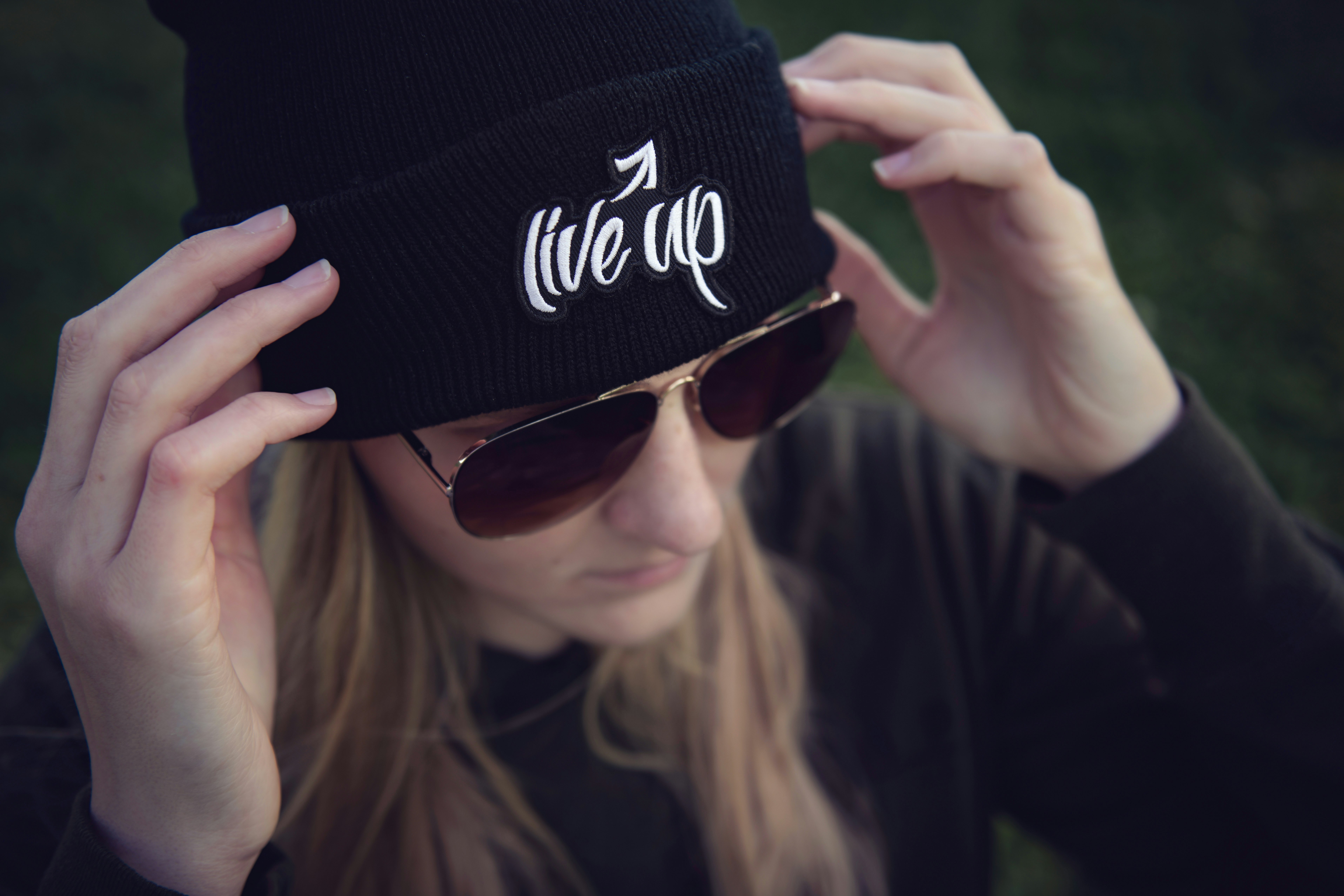 woman in black and white fitted cap and black sunglasses