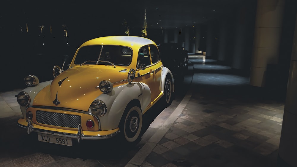 yellow volkswagen beetle parked on sidewalk during night time
