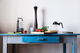 black and silver coffee maker on blue table