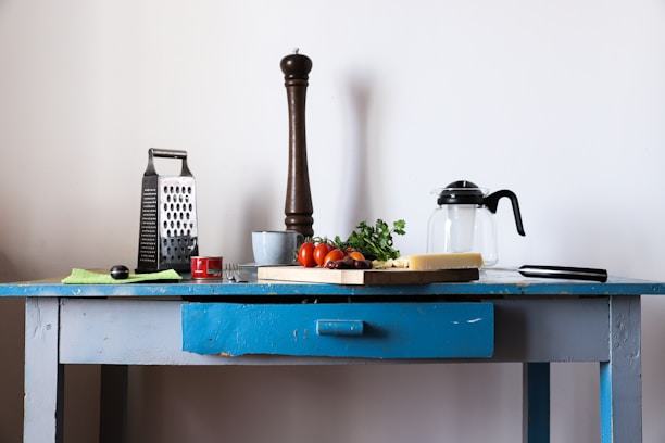 black and silver coffee maker on blue table