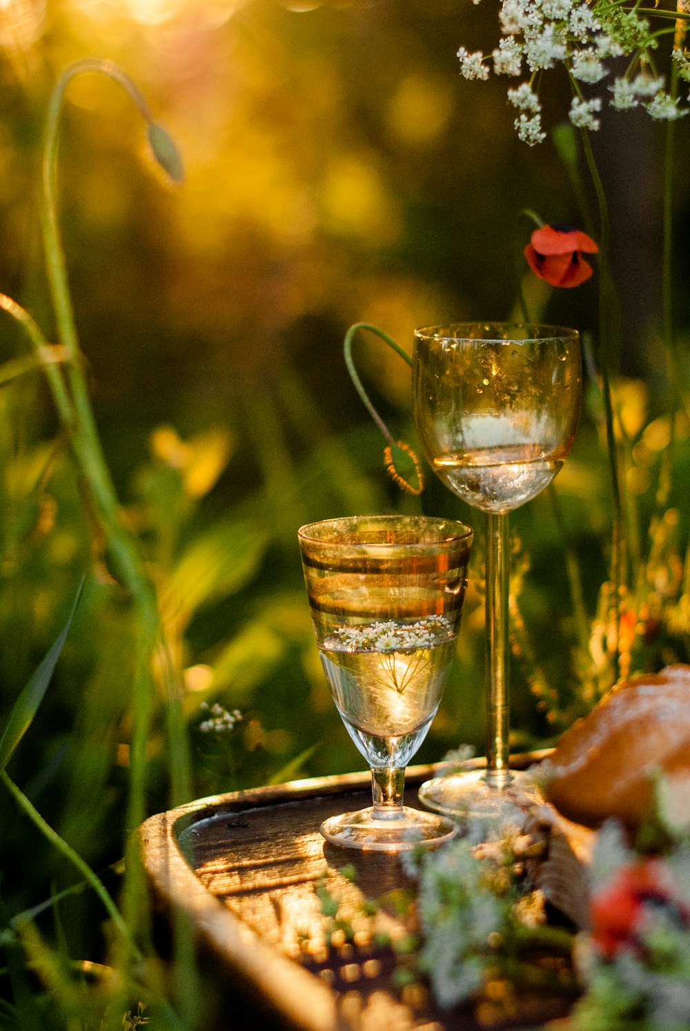 3 clear wine glasses on brown wooden table