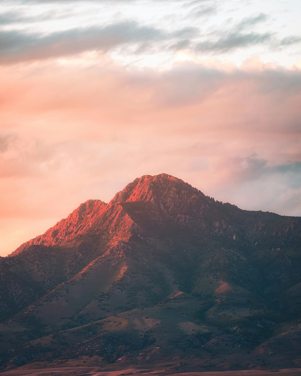 brown rocky mountain under cloudy sky during daytime