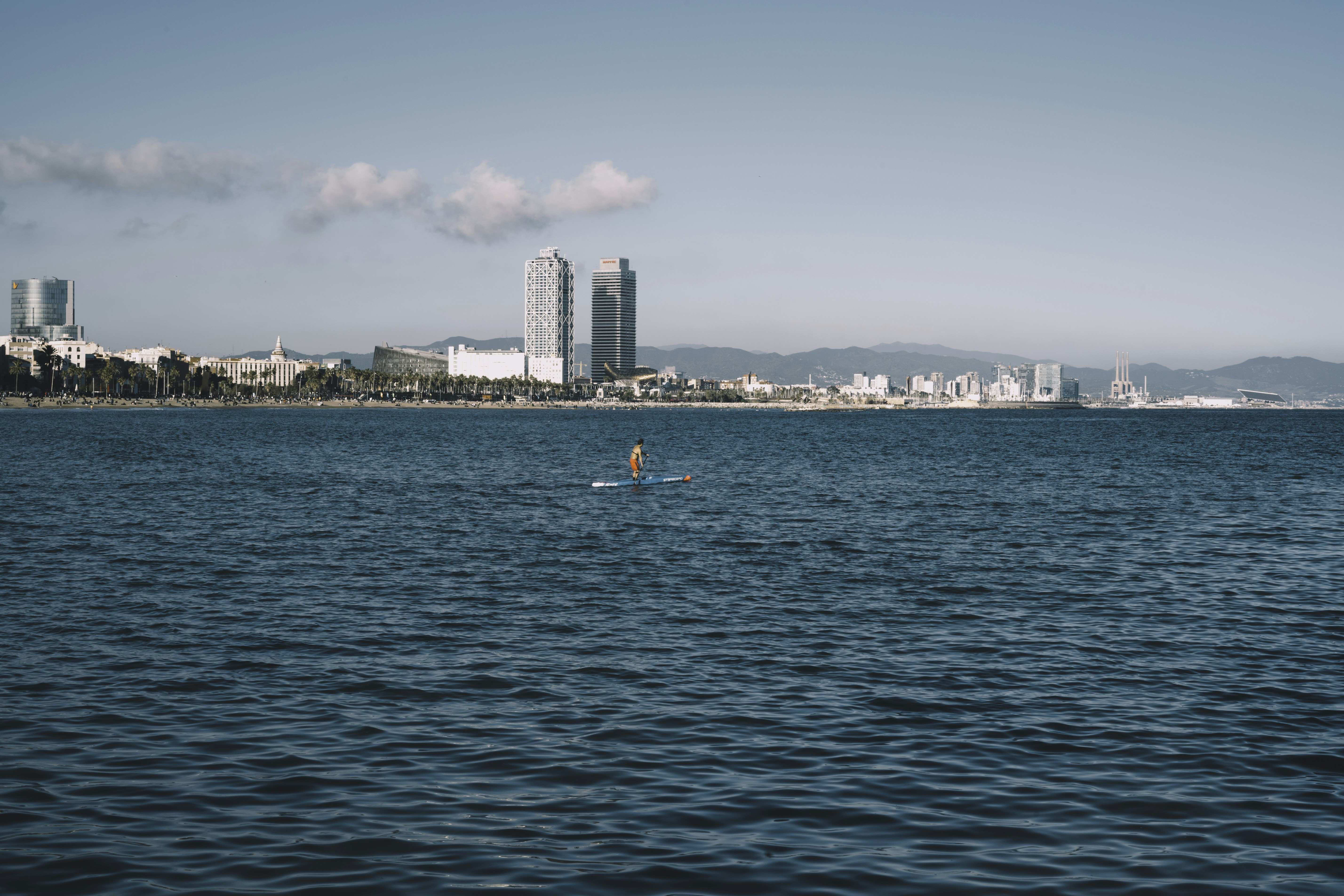 A lifeguard paddling on his boat on the Mediterranean sea, in Barcelona's beach 🇪🇸