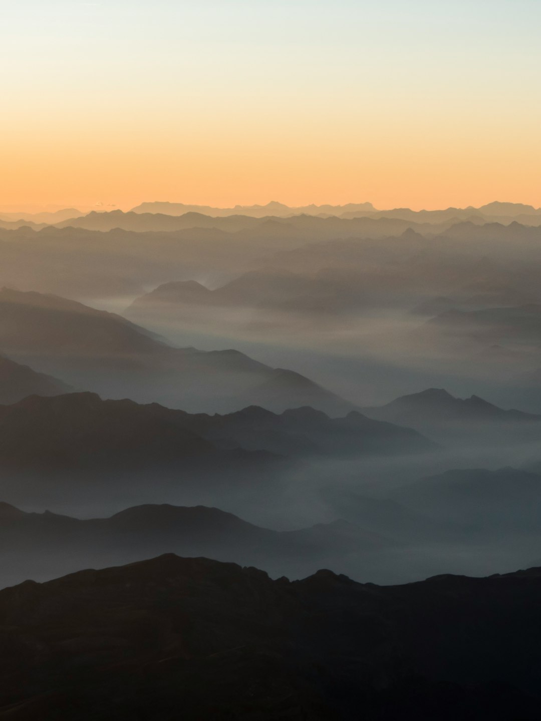 mountains under white clouds during daytime