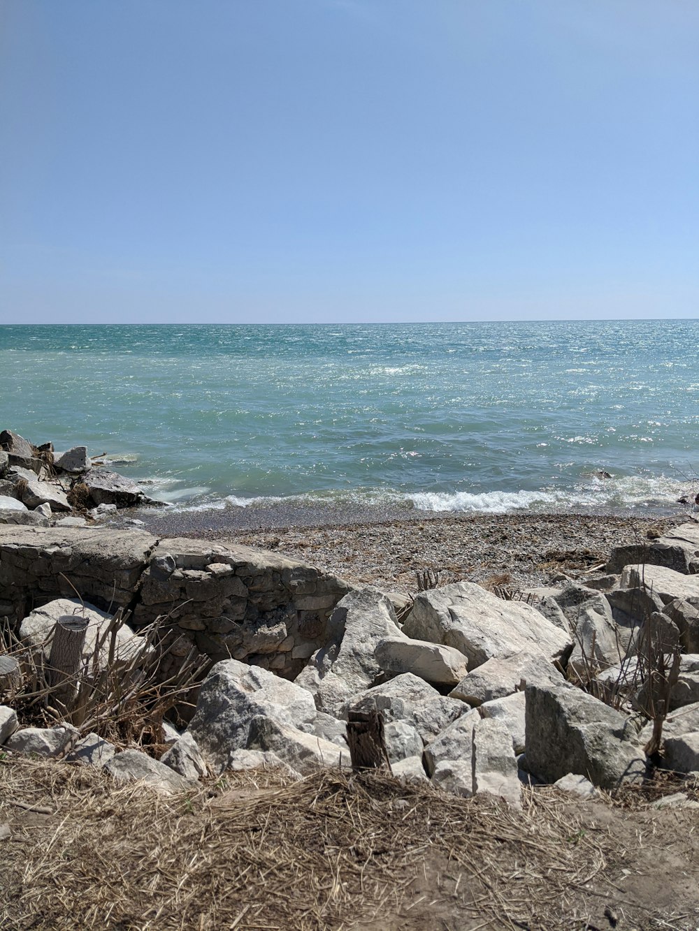 brown rocks near body of water during daytime