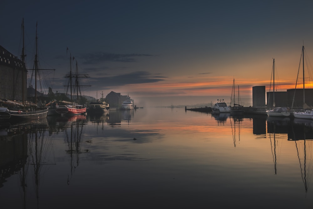 silhouette of boat on sea during sunset