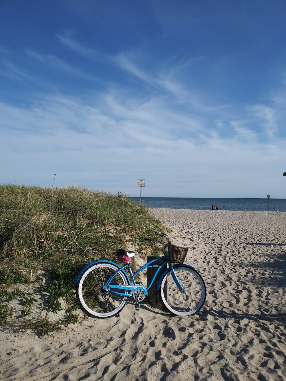 blue and black bicycle on beach during daytime
