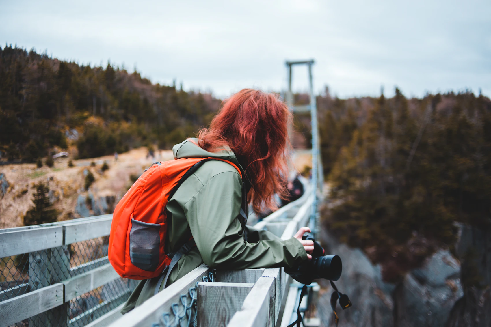 Photographer with camera and backpack composing a travel shooting scene