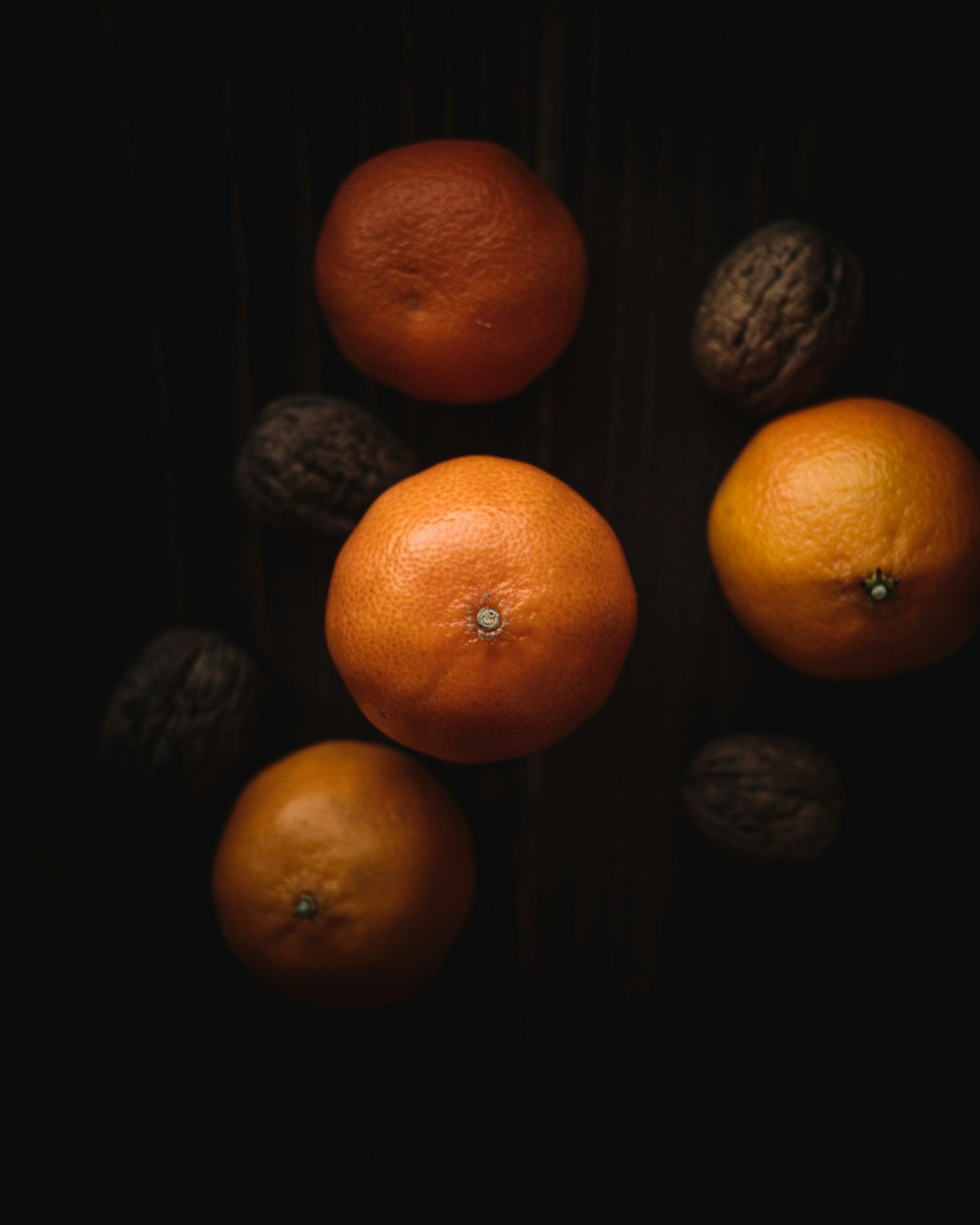 orange fruits on black surface