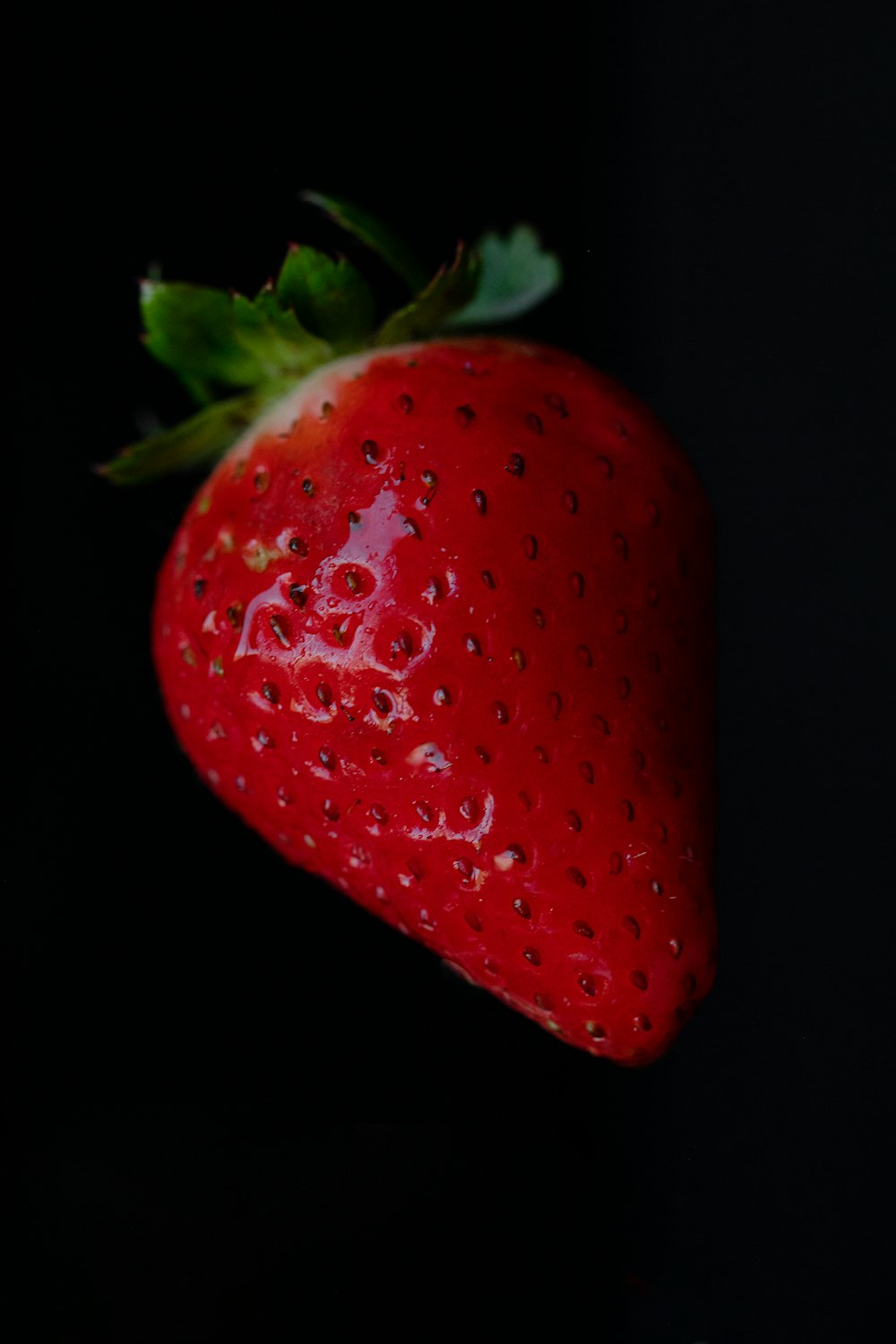 red strawberry in black background