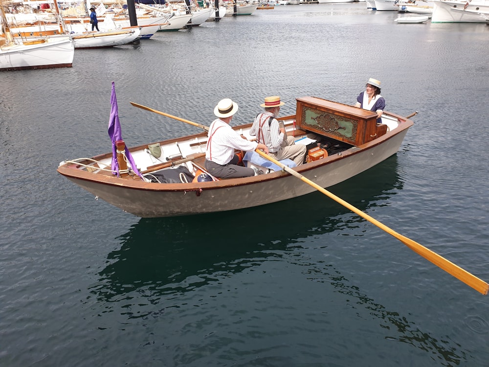 man and woman riding on brown boat on river during daytime