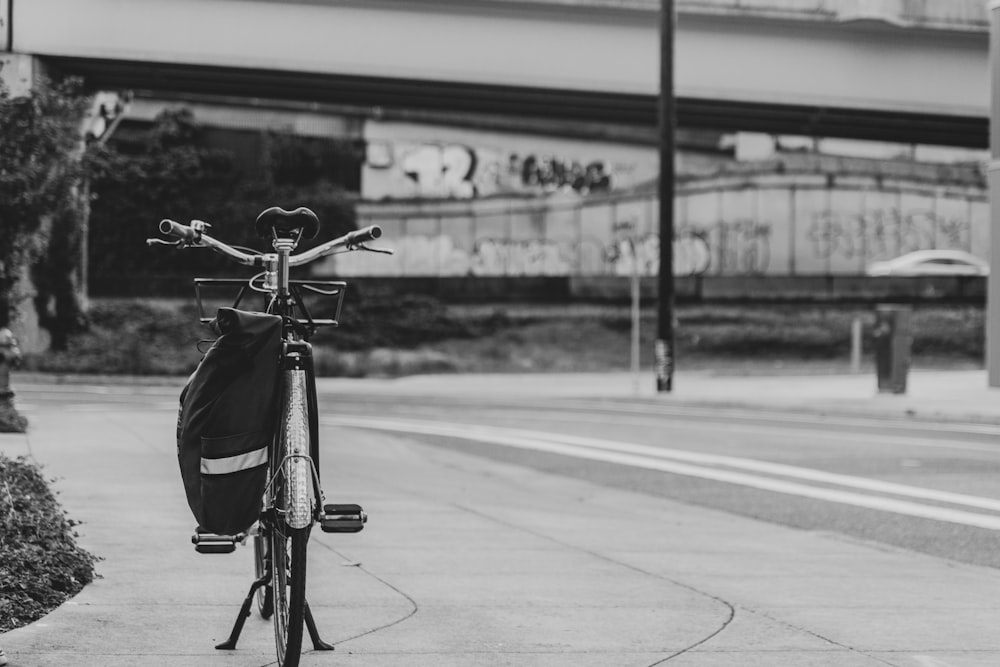 grayscale photo of a bicycle on a road