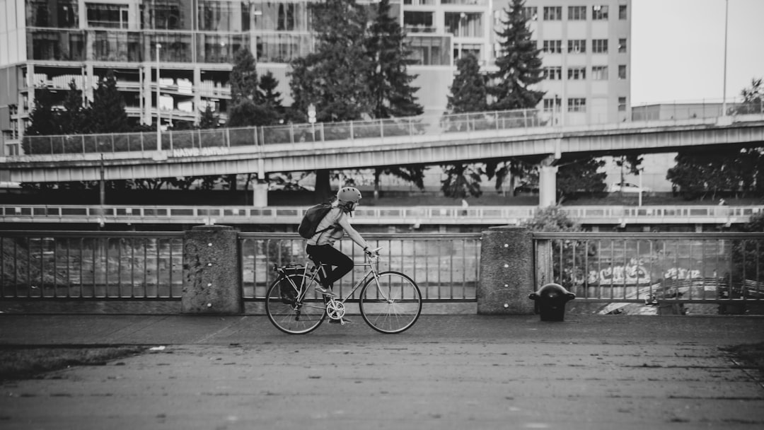 grayscale photo of woman riding bicycle