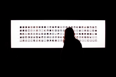 silhouette of woman standing in front of white and black frame word teams background