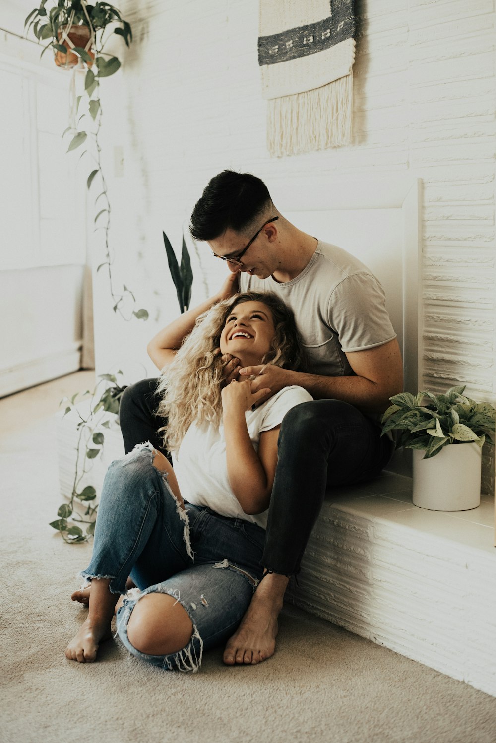 man in brown crew neck t-shirt sitting beside woman in beige long sleeve shirt