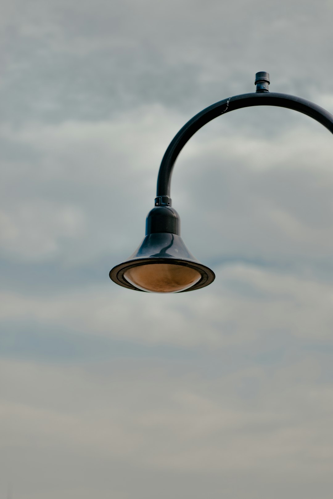 black and blue street light under cloudy sky during daytime