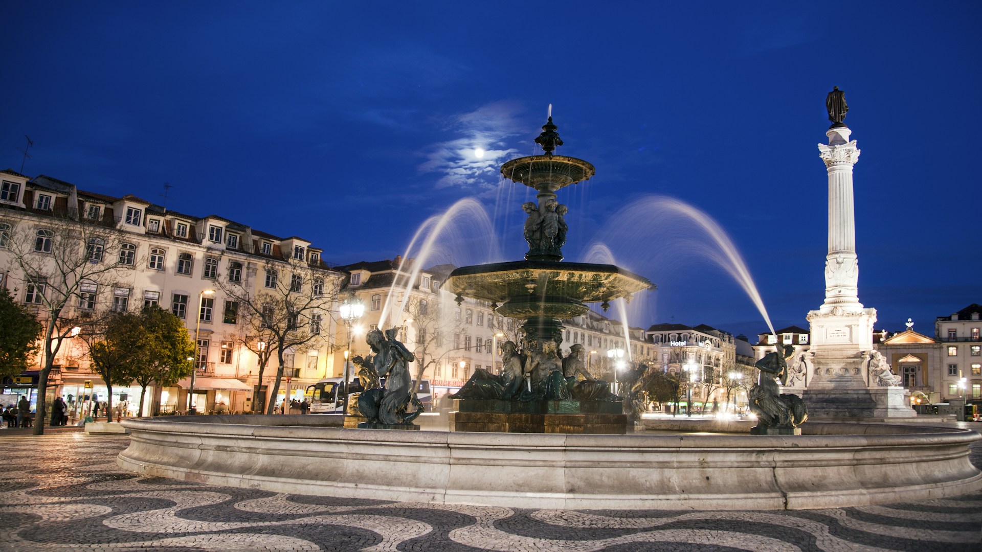water fountain in the middle of the city during night time