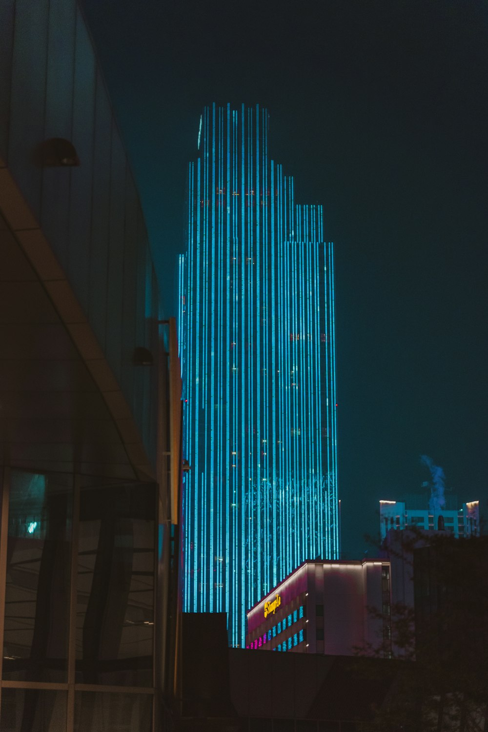 blue and black high rise building during night time