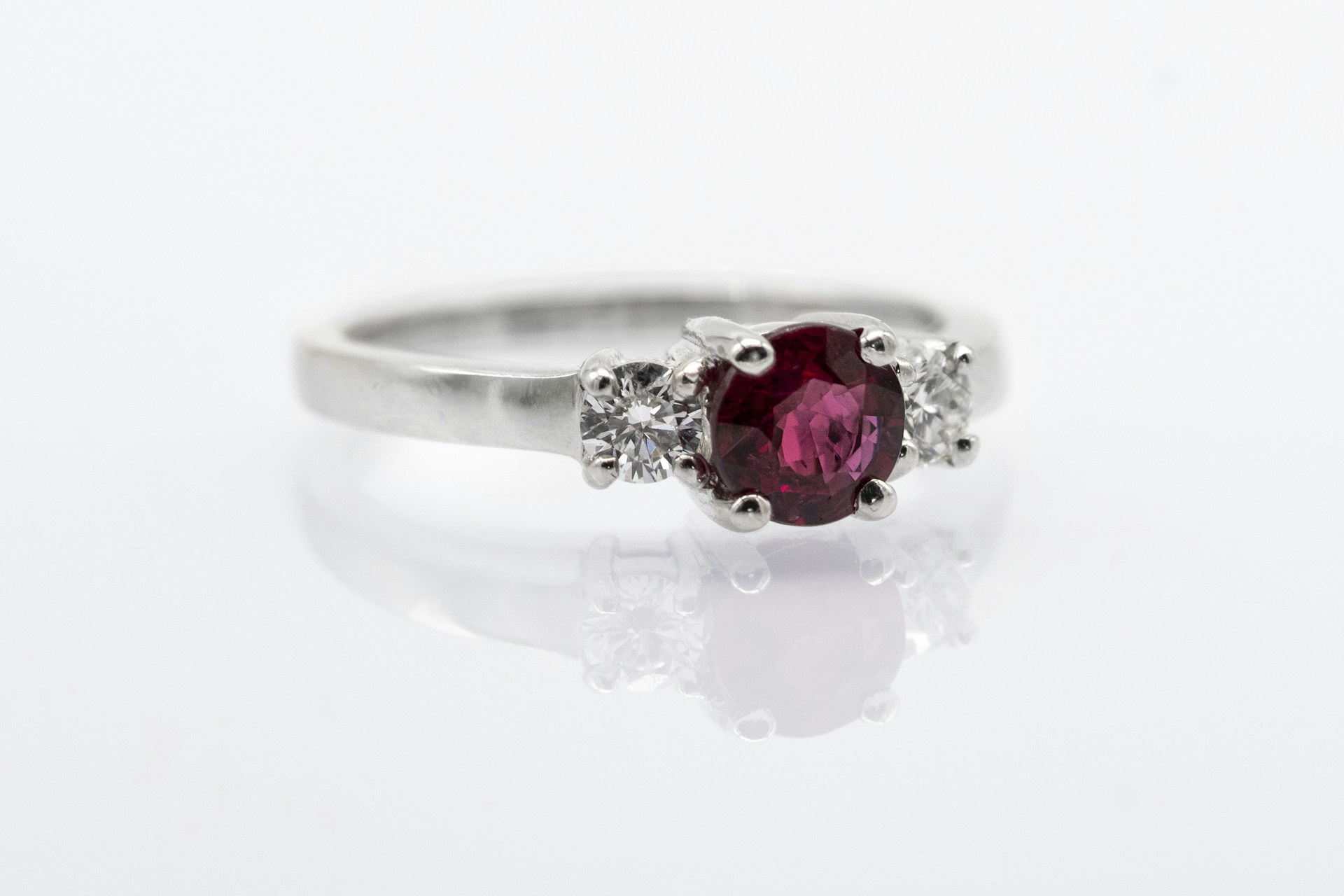 silver and red gemstone ring