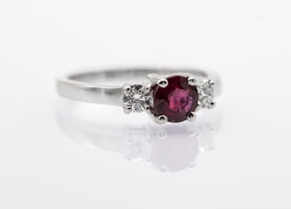 silver and red gemstone ring