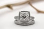silver diamond studded ring on white surface