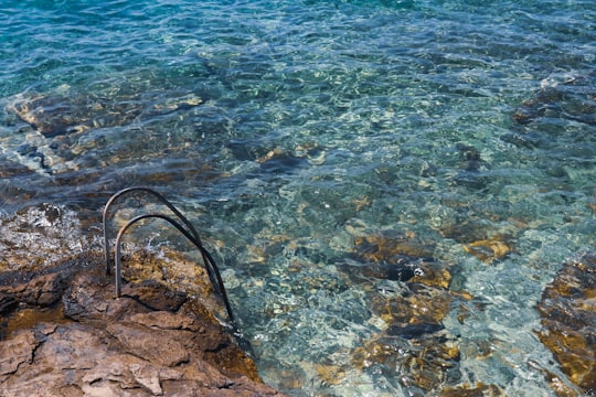 brown rock formation on body of water during daytime in Split Croatia