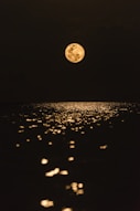 full moon over the body of water