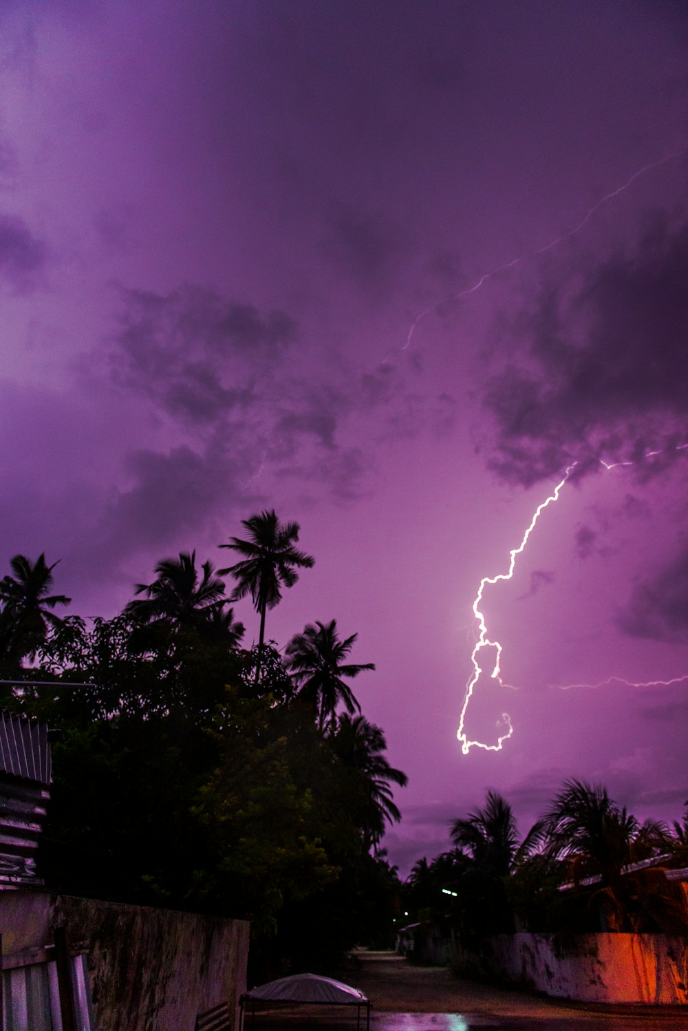 a purple sky with a lightning bolt in the distance