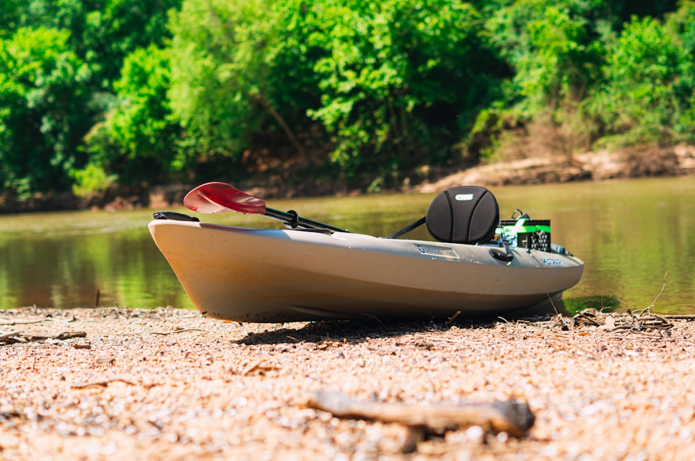 white and red boat on brown soil during daytime