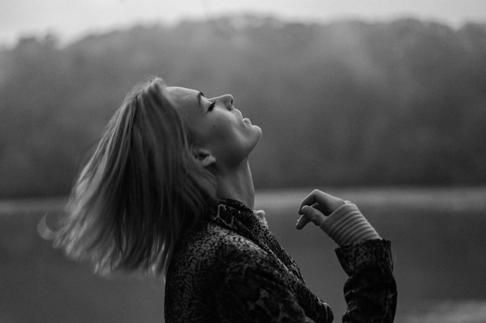 grayscale photo of woman in black and white floral long sleeve shirt