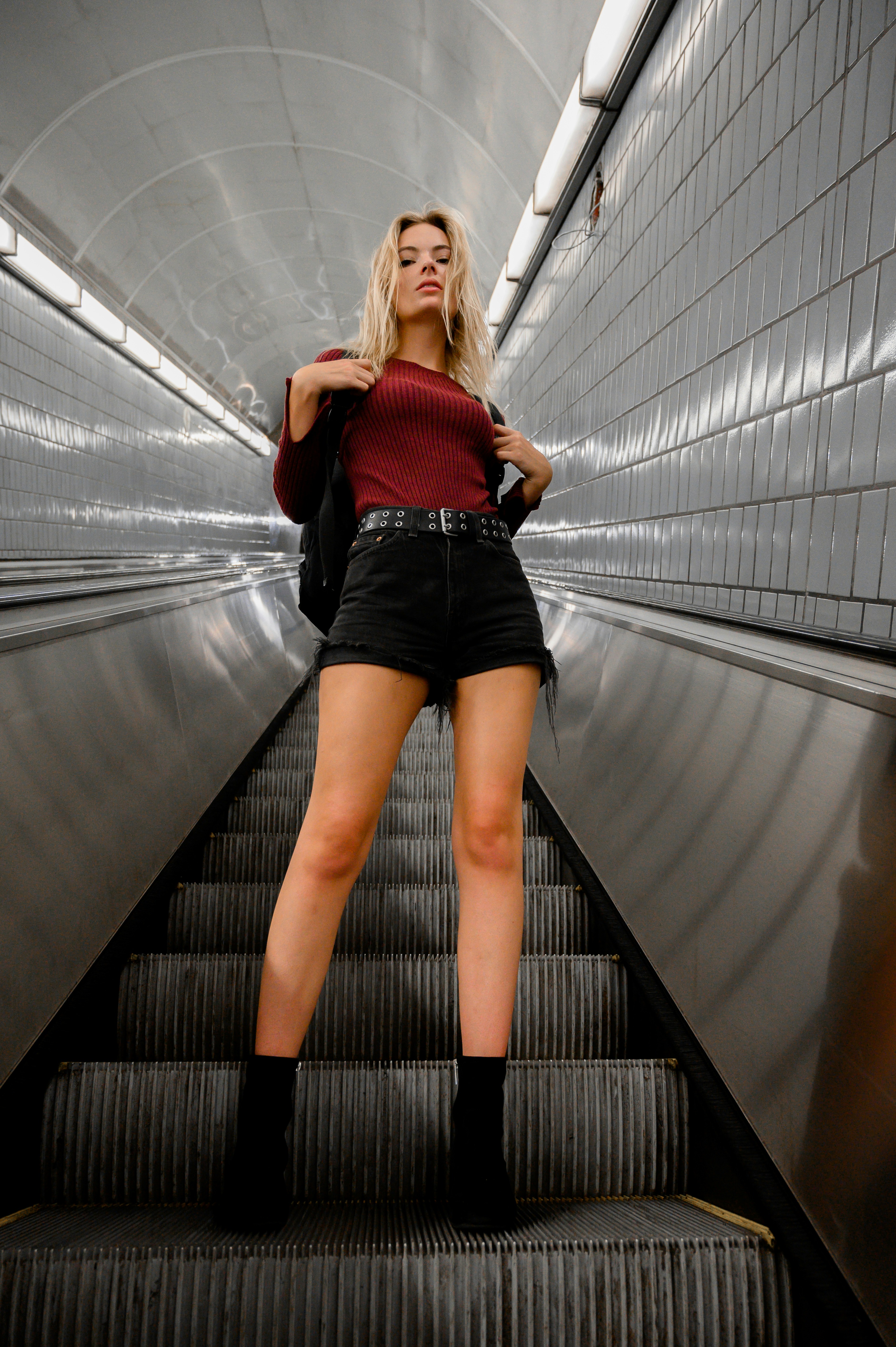 great photo recipe,how to photograph woman in red long sleeve shirt and black skirt walking on gray concrete stairs
