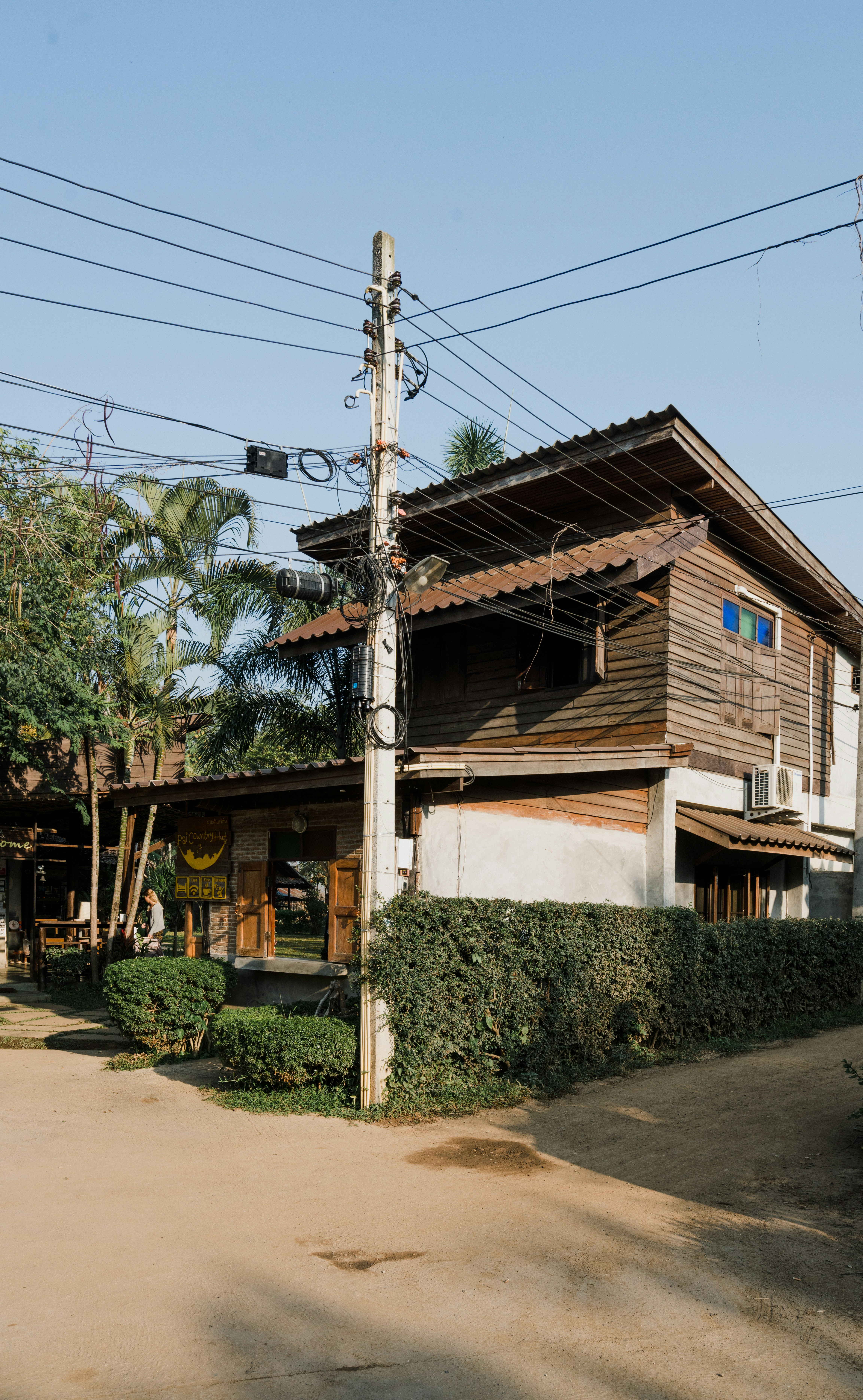 brown wooden house near green trees during daytime
